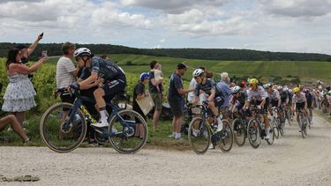 Team Visma - Lease a Bike team's Dutch rider Bart Lemmen (L) cycles with the pack of riders (peloton) over the Baroville 