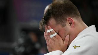 Germany's Timo Cavelius reacts after loosing to Israel's Sagi Muki (Blue) in the judo men's -81kg round of 32 bout of the Paris 2024 Olympic Games at the Champ-de-Mars Arena, in Paris on July 30, 2024.  
Luis ROBAYO / AFP