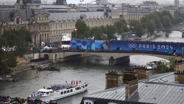 Paris 2024 Olympics - Opening Ceremony - Paris, France - July 26, 2024. Athletes of South Korea, Ivory Coast, Costa Rica and Democratic Republic of Congo aboard a boat in the floating parade pass the Musee du Louvre on the river Seine during the opening ceremony. 
Peter Cziborra / POOL / AFP