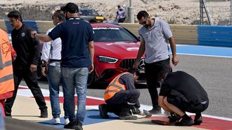 Maintenance staff repair a loose drainage grid during the third day of the Formula One pre-season testing at the Bahrain International Circuit in Sakhir on February 23, 2024. 
Andrej ISAKOVIC / AFP