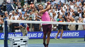 Spain's Carlos Alcaraz hits balls to the crowd after winning the men's singles semifinal tennis match against Serbia's Novak Djokovic on day thirteen of the US Open tennis tournament at the USTA Billie Jean King National Tennis Center in New York City, on September 5, 2025. 
TIMOTHY A. CLARY / AFP