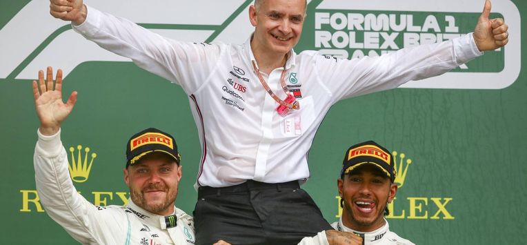 epa07716927 British Formula One driver Lewis Hamilton of Mercedes AMG GP (R) celebrates winning the Formula One Grand Prix of Great Britain with John Owen (head of design at Mercedes AMG) and Finnish Formula One driver Valtteri Bottas of Mercedes AMG GP (L) at the Silverstone circuit, in Northamptonshire, Britain, 14 July 2019.  EPA/GEOFF CADDICK