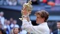 Italy's Jannik Sinner poses with the Gentleman's Singles trophy after his victory against Germany's Alexander Zverev at the end of their men's singles final tennis match on the last day of the 2026 Wimbledon Championships at The All England Lawn Tennis and Croquet Club in Wimbledon, southwest London, on July 12, 2026. 
Henry NICHOLLS / AFP