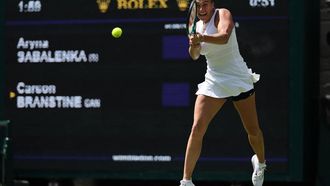 Belarus's Aryna Sabalenka plays a backhand return to US-Canada's Carson Branstine during their women's singles first round tennis match on the first day of the 2025 Wimbledon Championships at The All England Lawn Tennis and Croquet Club in Wimbledon, southwest London, on June 30, 2025. 
Adrian Dennis / AFP