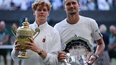 Italy's Jannik Sinner (L) poses with the Gentlemen's Singles Trophy after winning the men's singles final tennis match against Germany's Alexander Zverev (R) on the last day of the 2026 Wimbledon Championships at The All England Lawn Tennis and Croquet Club in Wimbledon, southwest London, on July 12, 2026. 
Henry NICHOLLS / AFP