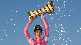 Team Visma Lease a Bike Danish rider Jonas Vingegaard wearing the overall leader's pink jersey holds the trophy as he celebrates on the podium after winning the Giro d'Italia 2026 - Tour of Italy cycling race between Rome and Rome, Italy, on May 31, 2026. 
Luca Bettini / AFP