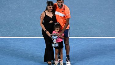 India's Rohan Bopanna poses with his family after victory against Italy's Simone Bolelli and Andrea Vavassori during their men's doubles final match on day 14 of the Australian Open tennis tournament in Melbourne on January 27, 2024. 
WILLIAM WEST / AFP