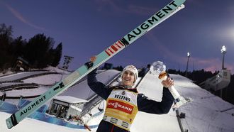 epa11801629 First placed Daniel Tschofenig of Austria cheers with the trophy after the second stage of the 73rd Four Hills Ski Jumping Tournament in Garmisch-Partenkirchen, Germany, 01 January 2025.  EPA/ANNA SZILAGYI