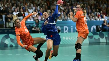 France's right back #20 Laura Flippes (C) attempts to score past Netherlands' centre back #79 Estavana Polman and Netherlands' left wing #12 Bo van Wetering during the Women's Preliminary Round Group B handball match between France and Netherlands of the Paris 2024 Olympic Games, at the Paris South Arena in Paris, on July 28, 2024.   
Damien MEYER / AFP