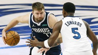 epa11376587 Dallas Mavericks guard Luka Doncic (L) dribbles past Minnesota Timberwolves forward Anthony Edwards (R) during the first half of the NBA Western Conference Finals playoff game four between the Minnesota Timberwolves and the Dallas Mavericks in Dallas, Texas, USA, 28 May 2024.  EPA/ADAM DAVIS SHUTTERSTOCK OUT