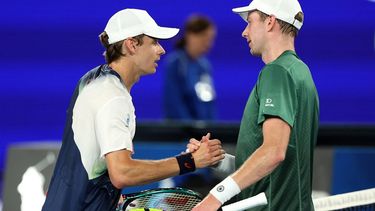 Australia's Alex De Minaur (L) shakes hands with Netherlands' Botic van de Zandschulp after their men's singles match on day three of the Australian Open tennis tournament in Melbourne on January 14, 2025. 
Martin KEEP / AFP