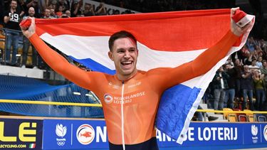 First placed Netherlands' Harrie Lavreysen celebrates with a Dutch flag after winning gold in the final round of the Men's Keirin race during the fifth day of the UEC European Track Cycling Championships at the Omnisport indoor arena in Apeldoorn, on January 14, 2024. 
JOHN THYS / AFP