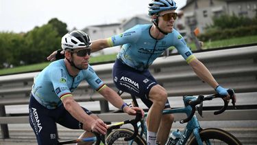 Astana Qazaqstan Team's Dutch rider Cees Bol (R) assists Astana Qazaqstan Team's British rider Mark Cavendish as they cycle in the final kilometres to make it to the finish line inside the cutoff during of the 111th edition of the Tour de France cycling race, 206 km between Florence and Rimini, in Italy, on June 29, 2024. 
Marco BERTORELLO / AFP