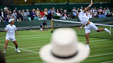 Members of the public watch Netherlands's David Pel (R) and Australia's Rinky Hijikata (L) play during their men's double tennis match on the seventh day of the 2025 Wimbledon Championships at The All England Lawn Tennis and Croquet Club in Wimbledon, southwest London, on July 6, 2025. 
Kirill KUDRYAVTSEV / AFP