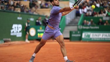 Spain's Carlos Alcaraz plays a forehand return to Italy's Lorenzo Musetti during the Monte Carlo ATP Masters Series Tournament final tennis match at the Monte Carlo Country Club in Roquebrune-Cap-Martin on April 13, 2025. 
Valery HACHE / AFP