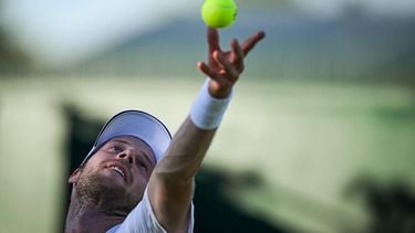 Netherlands' Botic Van De Zandschulp serves the ball to Italy's Matteo Arnaldi during their men's singles first round tennis match on the first day of the 2025 Wimbledon Championships at The All England Lawn Tennis and Croquet Club in Wimbledon, southwest London, on June 30, 2025. 
Kirill KUDRYAVTSEV / AFP