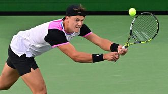 Denmark's Holger Rune hits a backhand return to USA's Taylor Fritz during their ATP-WTA Indian Wells Masters men's round of 16 tennis match at the Indian Wells Tennis Garden in Indian Wells, California, on March 13, 2024. 
Frederic J. BROWN / AFP