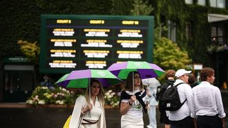Members of the public walk under their umbrella as the rain strats to fall on the third day of the 2025 Wimbledon Championships at The All England Lawn Tennis and Croquet Club in Wimbledon, southwest London, on July 2, 2025. 
HENRY NICHOLLS / AFP