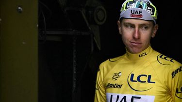 UAE Team Emirates team's Slovenian rider Tadej Pogacar celebrates on the podium with the overall leader's yellow jersey after the 14th stage of the 111th edition of the Tour de France cycling race, 151,9 km between Pau and Saint-Lary-Soulan Pla d'Adet, in the Pyrenees mountains in southwestern France, on July 13, 2024. 
Marco BERTORELLO / AFP