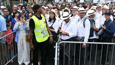 People queue outside the security perimeter as they arrive to attend the opening ceremony of the Paris 2024 Olympic Games in Paris on July 26, 2024. 
Natalia KOLESNIKOVA / AFP