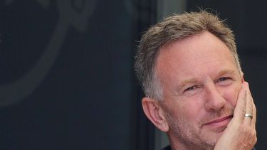 Red Bull Racing team principal Christian Horner listens to his teammates sitting outside at the paddock ahead of the first practice session of the Bahrain Formula One Grand Prix at the Bahrain International Circuit in Sakhir on February 29, 2024. 
Giuseppe CACACE / AFP