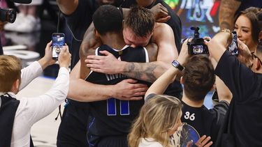 epa11351968 Dallas Mavericks guard Luka Doncic (C-R) hugs teammate Kyrie Irving after defeating the Oklahoma City Thunder in the NBA Western Conference Semifinal round playoff game six in Dallas, Texas, USA, 18 May 2024.  EPA/ADAM DAVIS SHUTTERSTOCK OUT