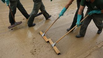 epa11694448 Officers of the INFOCA, a plan aimed to defend the Andalusian mountains against forest fires, clean a mud-covered street in Alora town, Malaga province, Andalusia region, Spain, 31 October 2024. There is no warning for rain or storms in the province of Malaga on 31 October, according to the State Meteorological Agency (AEMET), which reminded that the DANA (high-altitude isolated depression) phenomenon is still over Spain and that the meteorological emergency has not ended. More than 150 people died in the province of Valencia and neighboring provinces following floods caused by the DANA impacting the eastern part of the country.  EPA/JORGE ZAPATA