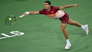 Spain's Carlos Alcaraz hits a return during his men’s singles quarter-final tennis match against Argentina’s Francisco Cerundolo at the BNP Paribas Open at the Indian Wells Tennis Garden in Indian Wells, California, on March 13, 2025. 
Patrick T. Fallon / AFP