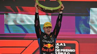 Red Bull Racing's Dutch driver Max Verstappen raises the trophy at the podium of the Formula One Sao Paulo Grand Prix, at the Jose Carlos Pace racetrack, aka Interlagos, in Sao Paulo, Brazil, on November 3, 2024. 
NELSON ALMEIDA / AFP