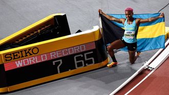 First-placed Bahamas' Devynne Charlton poses next to the score board reading her world record after winning the Women's 60m hurdles final during the Indoor World Athletics Championships in Glasgow, Scotland, on March 3, 2024. 
Anne-Christine POUJOULAT / AFP