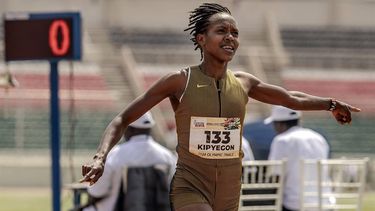 Kenyan 1500m world record holder Faith Kipyegon points to the time of her race in the stadium clock while celebrating her victory in the 1500m Women Final during the Kenya Athletics 2024 Paris Olympic Trials at the Nyayo National Stadium in Nairobi, on June 15, 2024. 
LUIS TATO / AFP