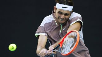 epa11097775 Taylor Fritz of the USA in action against Novak Djokovic of Serbia during the men's singles quarterfinals at the Australian Open tennis tournament in Melbourne, Australia, 23 January 2024.  EPA/MAST IRHAM