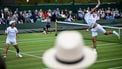 Members of the public watch Netherlands's David Pel (R) and Australia's Rinky Hijikata (L) play during their men's double tennis match on the seventh day of the 2025 Wimbledon Championships at The All England Lawn Tennis and Croquet Club in Wimbledon, southwest London, on July 6, 2025. 
Kirill KUDRYAVTSEV / AFP