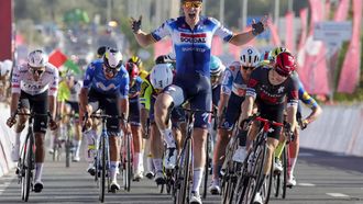 Belgium's Tim Merlier (C) of Soudal Quick-Step celebrates as he crosses the finish line to win stage 1 of the 6th UAE Tour 2024, from Al Dhafra Walk to Liwa, on February 19, 2024. 
Giuseppe CACACE / AFP