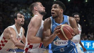 Greece’s Giannis Antetokounmpo (R) is marked by Croatia’s Ivica Zubak (C) during the 2024 FIBA Olympic Qualifying Tournament final basketball match between Greece and Croatia at the Peace and Friendship Stadium in Athens, on July 7, 2024. 
Aris MESSINIS / AFP