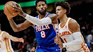 epa11659795 Philadelphia 76ers forward Paul George (L) in action against Atlanta Hawks forward Jalen Johnson during the first half of an NBA preseason game against the Philadelphia 76ers in Atlanta, Georgia, USA, 14 October 2024.  EPA/ERIK S. LESSER SHUTTERSTOCK OUT