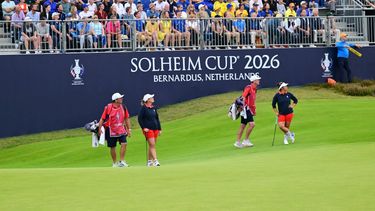 US teams golfer Megan Khang (R) and US teams golfer Lauren Coughlin (2L) stand with their caddies during play in their fourball match against Team Europe players on the second day of the 2026 Solheim Cup biennial team golf competition on The Bernardus Golf Course at Cromvoirt, some 80kms south-east of Rotterdam on September 12, 2026.  
NICOLAS TUCAT / AFP