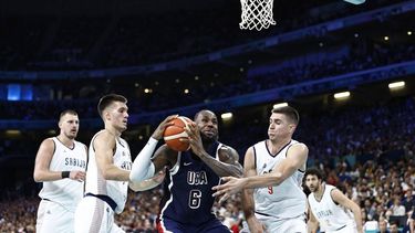 USA's #06 LeBron James attempts to go to the basket past Serbia's #03 Filip Petrusev (L) and Serbia's #09 Vanja Marinkovic in the men's preliminary round group C basketball match between Serbia and USA during the Paris 2024 Olympic Games at the Pierre-Mauroy stadium in Villeneuve-d'Ascq, northern France, on July 28, 2024. 
Sameer Al-Doumy / AFP