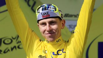 epa11477840 Slovenian rider Tadej Pogacar of UAE Team Emirates celebrates in the overall leader's yellow jersey on the podium after winning the 15th stage of the 2024 Tour de France cycling race over 197km from Loudenvielle to Plateau de Beille, France, 14 July 2024.  EPA/GUILLAUME HORCAJUELO