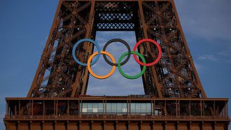 This photograph shows the Eiffel Tower, decorated with the Olympic rings for the upcoming Paris 2024 Olympic Games, in Paris, on July 18, 2024. 
EMMANUEL DUNAND / AFP