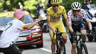 Team Visma - Lease a Bike team's Danish rider Jonas Vingegaard cycles ahead of UAE Team Emirates team's Slovenian rider Tadej Pogacar wearing the overall leader's yellow jersey in the final ascent of the Plateau de Beille during the 15th stage of the 111th edition of the Tour de France cycling race, 197,7 km between Loudenvielle and Plateau de Beille, in the Pyrenees mountains, southwestern France, on July 14, 2024. 
Marco BERTORELLO / AFP