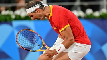 Spain's Rafael Nadal playing with Spain's Carlos Alcaraz reacts while playing Argentina's Maximo Gonzalez and Argentina's Andres Molteni during their men's doubles first round tennis match on Court Philippe-Chatrier at the Roland-Garros Stadium at the Paris 2024 Olympic Games, in Paris on July 27, 2024.  
Martin  BERNETTI / AFP