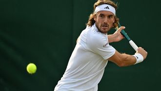 Greece's Stefanos Tsitsipas returns against Finland's Emil Ruusuvuori during their men's second round singles tennis match on the fourth day of the 2024 Wimbledon Championships at The All England Lawn Tennis and Croquet Club in Wimbledon, southwest London, on July 4, 2024. 
ANDREJ ISAKOVIC / AFP