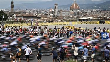 The pack of riders (peloton) cycles over an elevated vantage point overlooking the city of Florence at the start of the 1st stage of the 111th edition of the Tour de France cycling race, 206 km between Florence and Rimini, in Italy, on June 29, 2024. 
Marco BERTORELLO / AFP