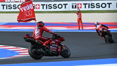 Ducati Lenovo Team's Spanish MotoGP rider Marc Marquez (L) celebrates winning the San Marino Moto GP Grand Prix alongside Aprilia Racing team's Italian MotoGP rider Marco Bezzecchi (R) at the Misano World Circuit Marco Simoncelli, in Misano Adriatico, northern Italy, on September 14, 2025. 
Andreas SOLARO / AFP