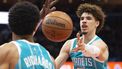 epa09598362 Charlotte Hornets guard LaMelo Ball (R) passes the ball during the first half of the NBA basketball game between the Charlotte Hornets and Washington Wizards, at Capital One Arena in Washington, DC, USA, 22 November 2021.  EPA/MICHAEL REYNOLDS SHUTTERSTOCK OUT