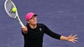 Poland's Iga Swiatek hits a forehand volley return to Ukraine's Marta Kostyuk during their ATP-WTA Indian Wells Masters women's semifinal tennis match at the Indian Wells Tennis Garden in Indian Wells, California, on March 15, 2024. 
Frederic J. BROWN / AFP