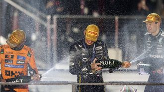 Race winner Red Bull Racing's Dutch driver Max Verstappen (C) celebrates with second place finisher McLaren's British driver Lando Norris (L) and third place finisher Mercedes' British driver George Russell (R) on the podium after the Las Vegas Formula One Grand Prix at the Las Vegas Strip Circuit in Las Vegas, Nevada, on November 22, 2025. 
Patrick T. Fallon / AFP