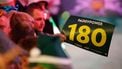epa11779768 A fan waves a '180' placard during the opening session of the Paddy Power World Darts Championship at Alexandra Palace in London, Britain 15 December 2024.  EPA/DAVID CLIFF