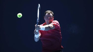 epa11081102 Roman Safiullin of Russia in action against Tallon Griekspoor of the Netherlands during the Men's 1st round match at the Australian Open tennis tournament in Melbourne, Australia, 16 January 2024.  EPA/MAST IRHAM